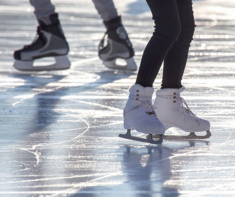 white ice skates on ice and pair of black ice skates on ice
