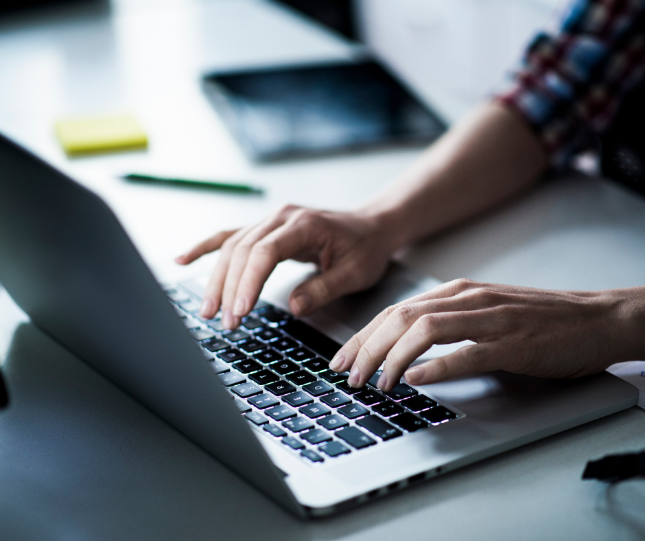 hands typing on a computer